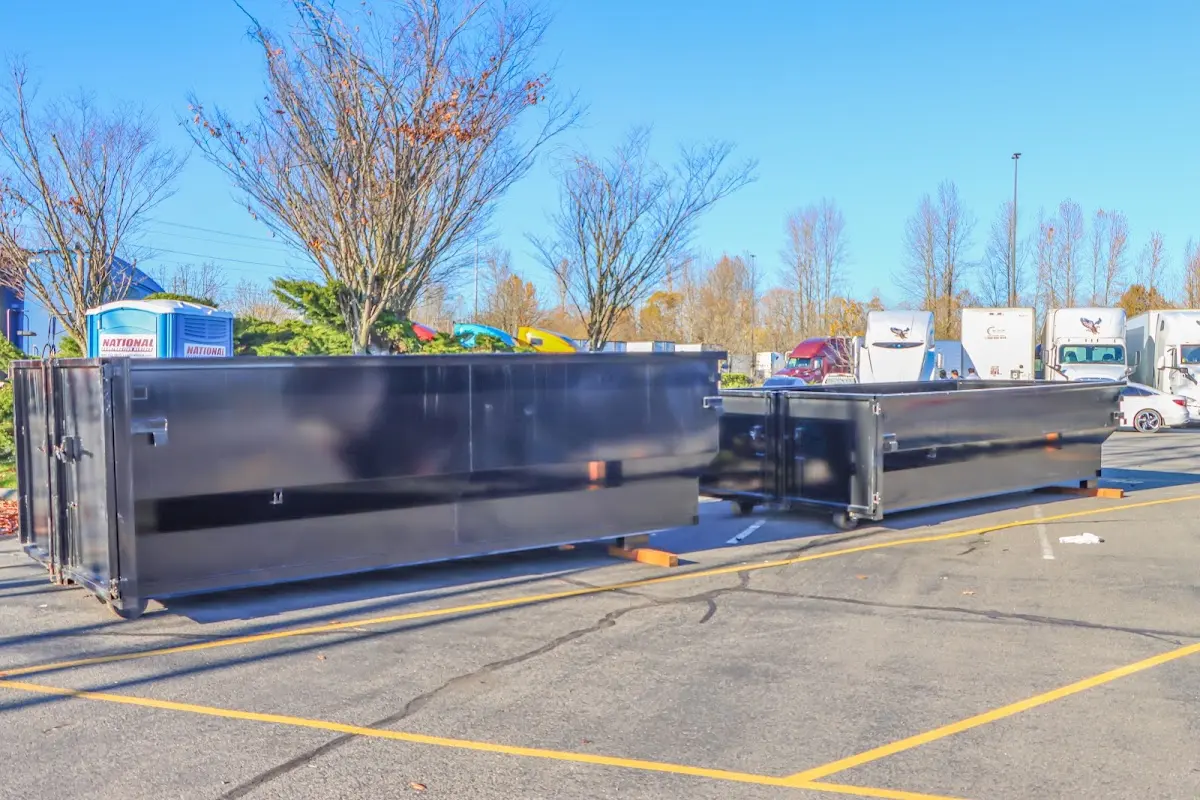 Professional dumpster rental service with roll-off container on residential driveway in Golden Gate